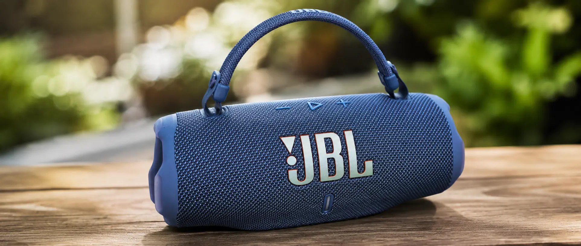 JBL Charge 6 in blue with the detachable carry strap attached
